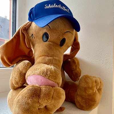Das Maskottchen der Schülerhilfe Kenzingen - ein brauner Plüsch-Elefant mit Schülerhilfe-Mütze.
